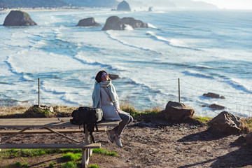 Cheerful female situating on coastline