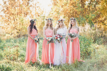 Bride with bridesmaids in pink dresses. A wedding in the summer.