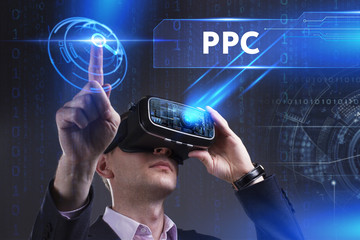 Business, Technology, Internet and network concept. Young businessman working in virtual reality glasses sees the inscription: PPC