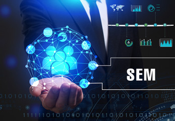 Business, Technology, Internet and network concept. Young businessman working on a virtual screen of the future and sees the inscription: SEM