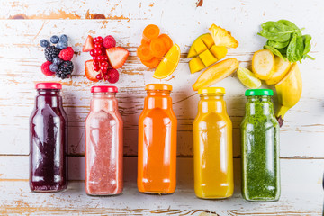 Selection of colourful smoothies on rustic wood background