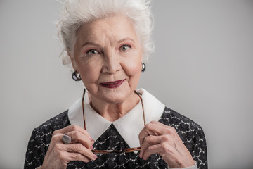 Trendy senior lady with lovely charming smile