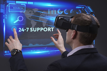 Business, Technology, Internet and network concept. Young businessman working on a virtual screen of the future and sees the inscription: 24-7 Support