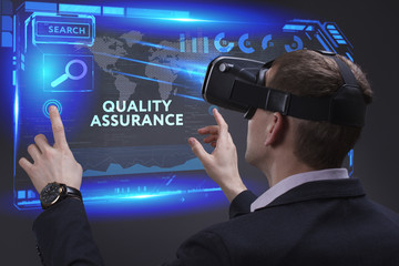 Business, Technology, Internet and network concept. Young businessman working on a virtual screen of the future and sees the inscription: Quality assurance