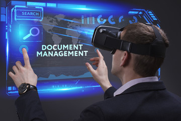 Business, Technology, Internet and network concept. Young businessman working on a virtual screen of the future and sees the inscription: Document management