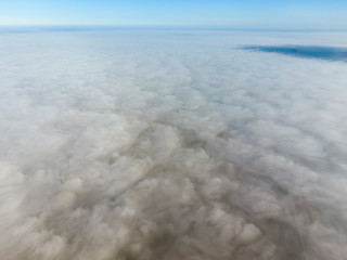 In the skies above the fog. Sunrise over the fog. Clouds near the ground