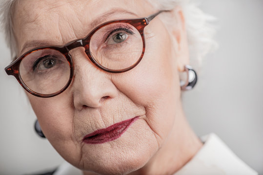 Elderly lady wearing glasses and looking sideward