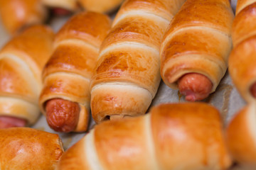 Sausage rolls, cooking food at home. Golden color crust.