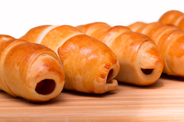 Sausage rolls, cooking food at home. Golden color crust.