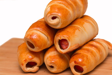 Sausage rolls, cooking food at home. Golden color crust.