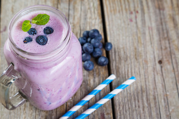 Obraz na płótnie Canvas Blueberry jogurt smoothie in glass jar
