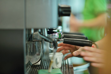 prepares espresso in his coffee shop, close-up