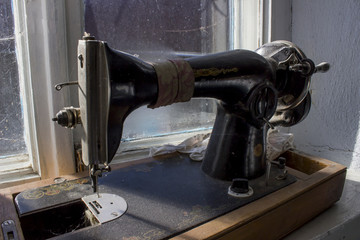 Black retro sewing machine in an old house