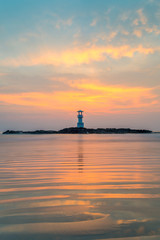 Seascape at sunset. Lighthouse on the coast