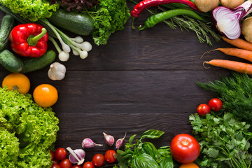 Frame of fresh vegetables on wooden background with copy space