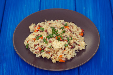 rice with chicken and vegetables on brown plate