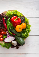 Border of fresh vegetables on wooden background with copy space