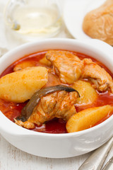 fish stew on white bowl on wooden background