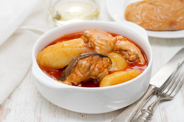 fish stew on white bowl on wooden background