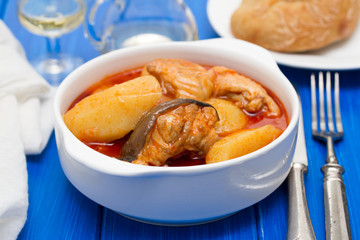 fish stew on white bowl on wooden background