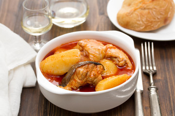 fish stew on white bowl on wooden background