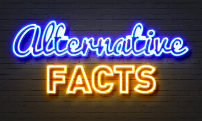 Obraz premium Alternative facts neon sign on brick wall background.