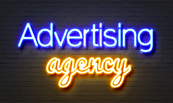 Advertising Agency Neon Sign On Brick Wall Background.