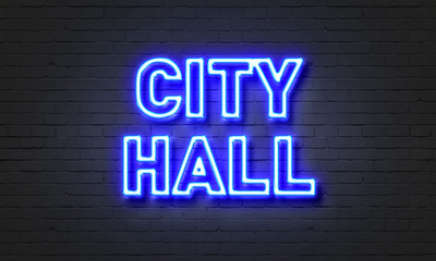 City hall neon sign on brick wall background.