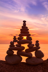 Stones balance on a background of sea sunset. Concept of harmony and balance