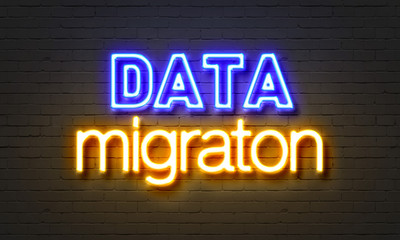 Obraz premium Data migration neon sign on brick wall background.