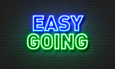 Obraz premium Easy going neon sign on brick wall background.