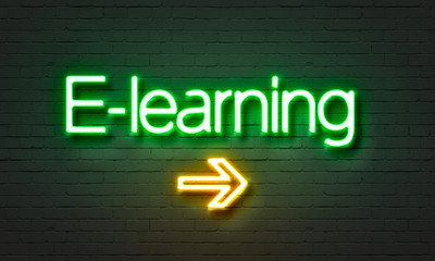 E-learning neon sign on brick wall background.