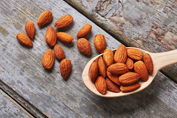 Almonds on wooden backdrop.