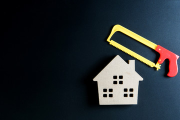 Wooden house toy and construction tools toy on black background with copy space.Home Repair concept, Repair maintenance concept, Renovation concept