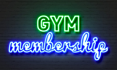 Gym membership neon sign on brick wall background.