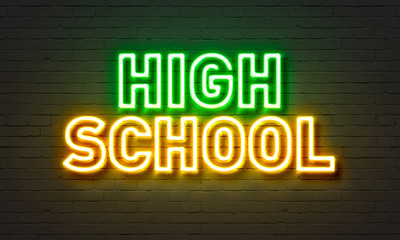 High school neon sign on brick wall background.