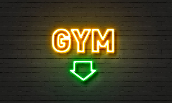 Gym Neon Sign On Brick Wall Background.