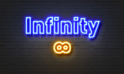 Fototapeta premium Infinity neon sign on brick wall background.