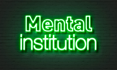 Mental institution neon sign on brick wall background.