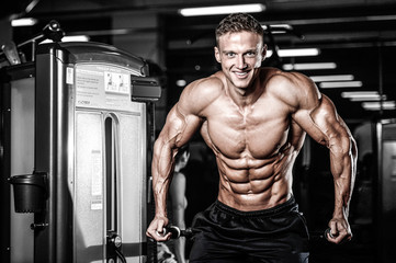 Fototapeta na wymiar Brutal caucasian handsome fitness men on diet training triceps gym