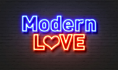 Modern love neon sign on brick wall background.