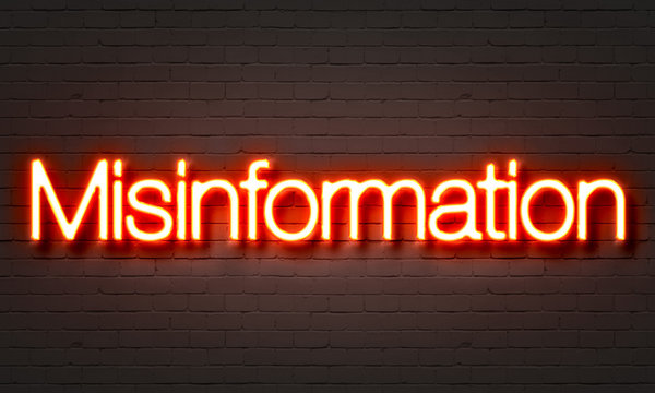 Misinformation Neon Sign On Brick Wall Background.