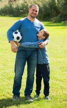 Son And Father At Football Field.