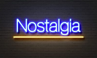 Nostalgia neon sign on brick wall background.