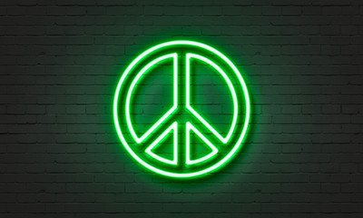 Peace symbol neon sign on brick wall background.