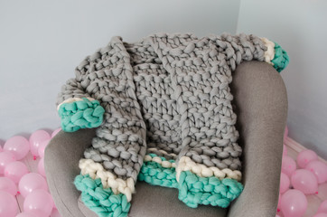 grey and blue merino wool jacket on arm chair