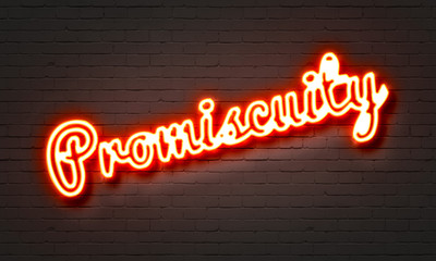 Fototapeta na wymiar Promiscuity neon sign on brick wall background.