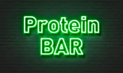 Protein bar neon sign on brick wall background.