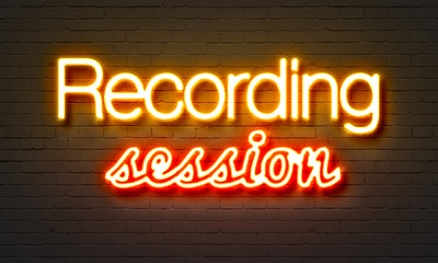 Recording session neon sign on brick wall background.