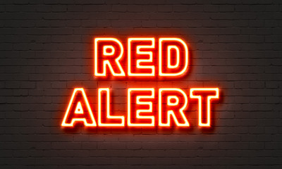 Red alert neon sign on brick wall background. - obrazy, fototapety, plakaty